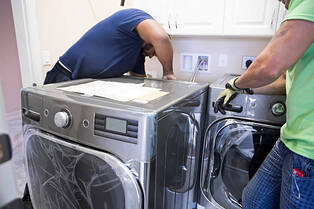 Electricians installing washer